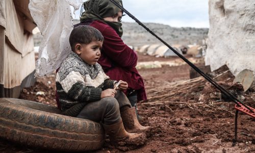 IDLIB, SYRIA - NOVEMBER 04: Syrians living in Khaled Ahmad Camp are seen amid mud as heavy rain and cold weather hit the camps in Syria on November 04, 2020. People wait for aid as they live under deadly conditions without proper shelter, food and cloth. (Photo by Muhammed Abdullah/Anadolu Agency via Getty Images)